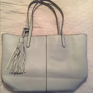 Gray purse with a tassle